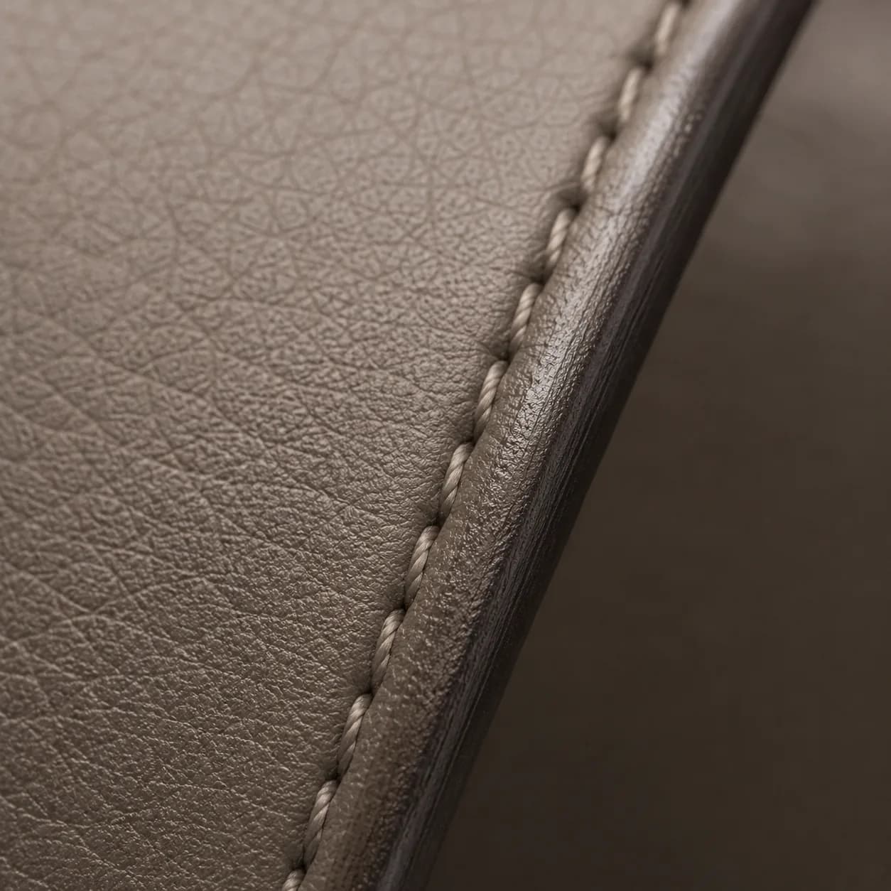 PORTALE, close view of the taupe leather, stitching and burnished edge