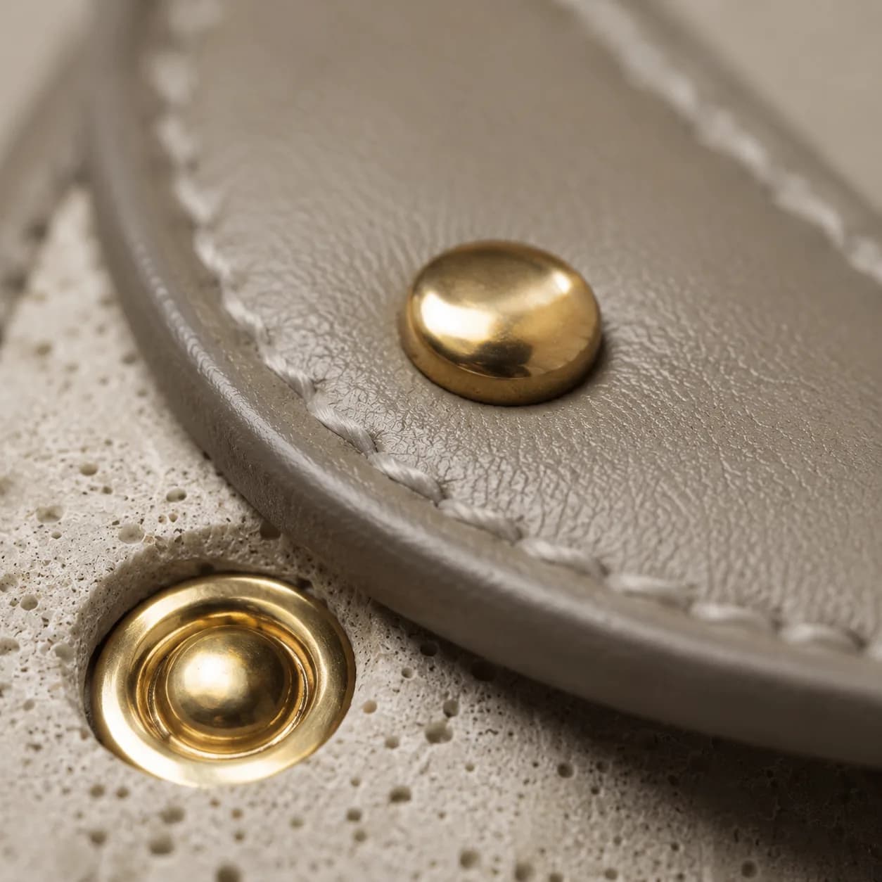 PORTALE, close view of the gilded brass rivet and snap